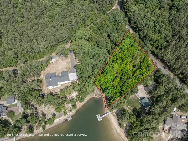 an aerial view of residential house with outdoor space and trees all around