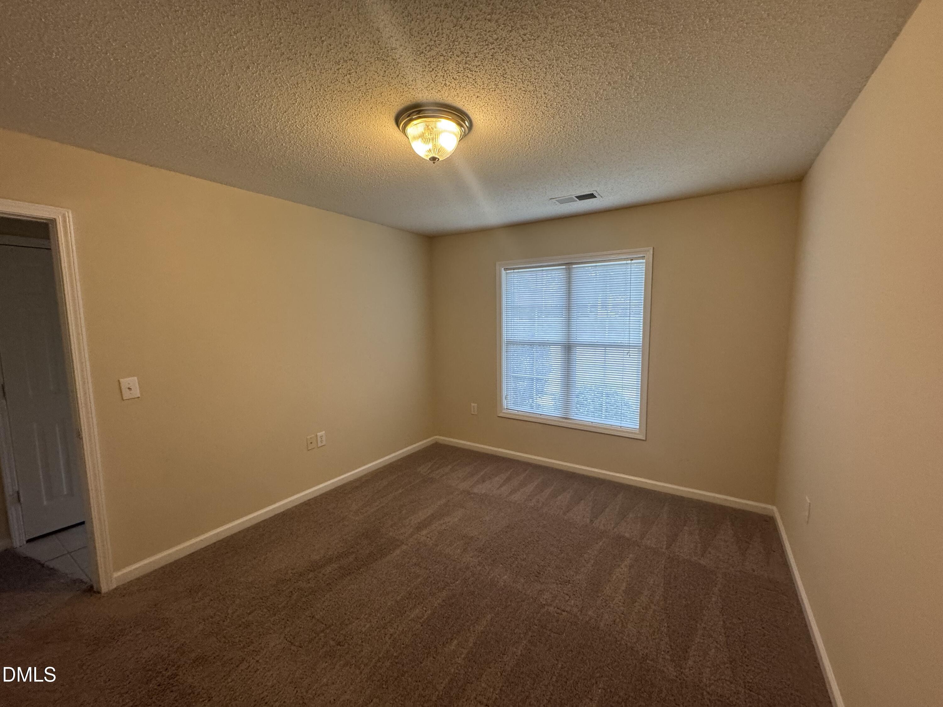 Undisclosed Address Raleigh, NC 27617 - Photo 6 of 22 an empty room with a empty space and a window