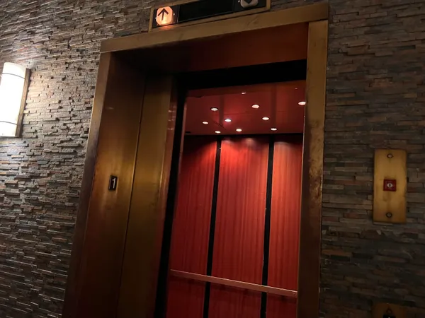 a hallway with sliding door and wooden floor