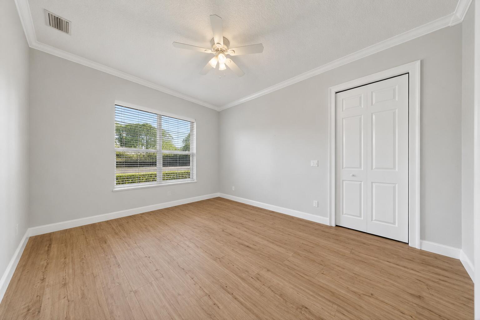 8686 Andrews Avenue Fort Pierce, FL 34945 - Photo 33 of 76 an empty room with wooden floor and windows