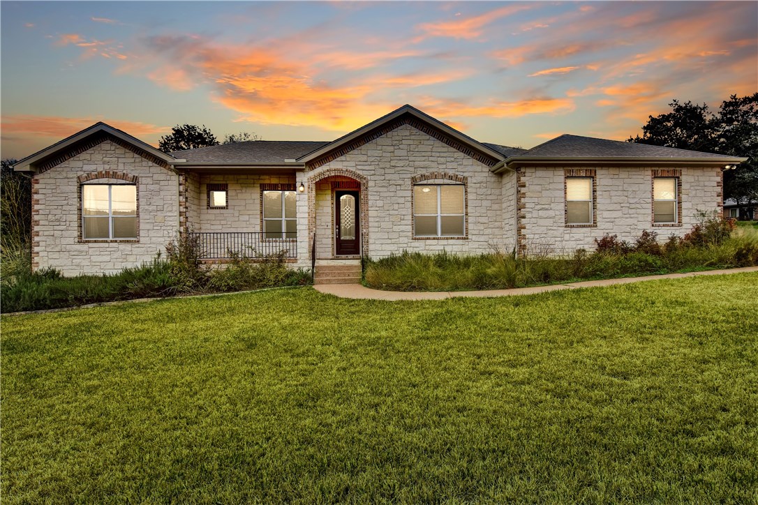 a view of a house with a yard and plants