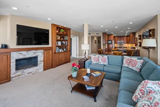 a living room with fireplace furniture and a flat screen tv