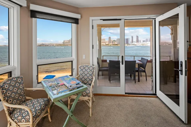 a view of a livingroom with furniture and floor to ceiling window