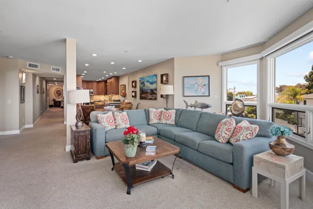 a living room with furniture and kitchen view