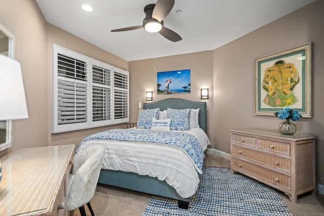 a bedroom with a bed and a dresser in it