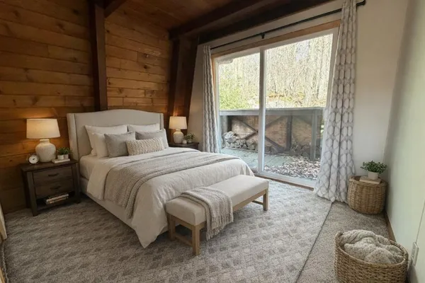 a spacious bedroom with a bed and glass door