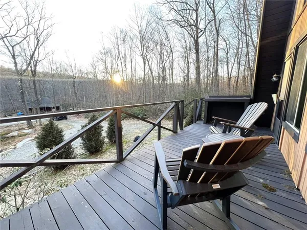 a view of a balcony with wooden floor and outdoor seating