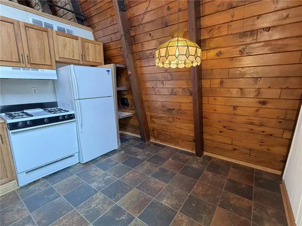 a kitchen with a cabinets and a stove top oven