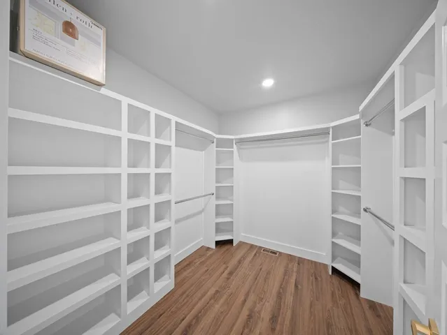 a view of walk in closet with empty racks
