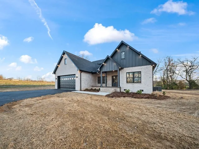 a view of an house with backyard space and ocean view