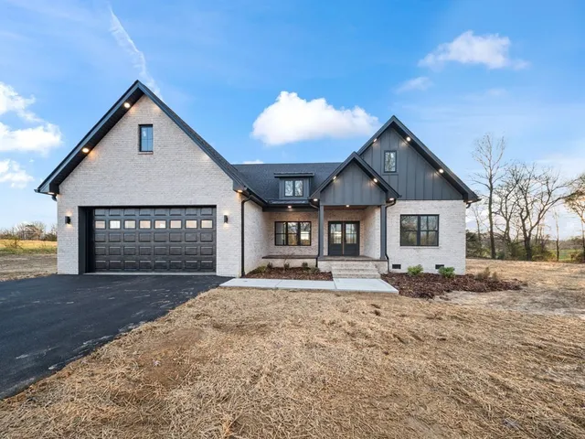 a view of a house with a yard and refrigerator