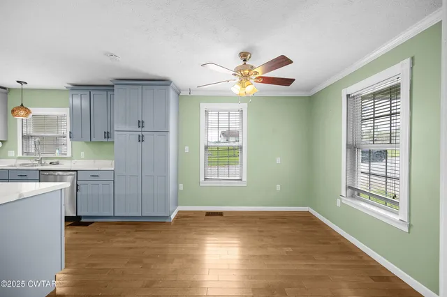 a view of a kitchen with a dishwasher cabinets and a large window
