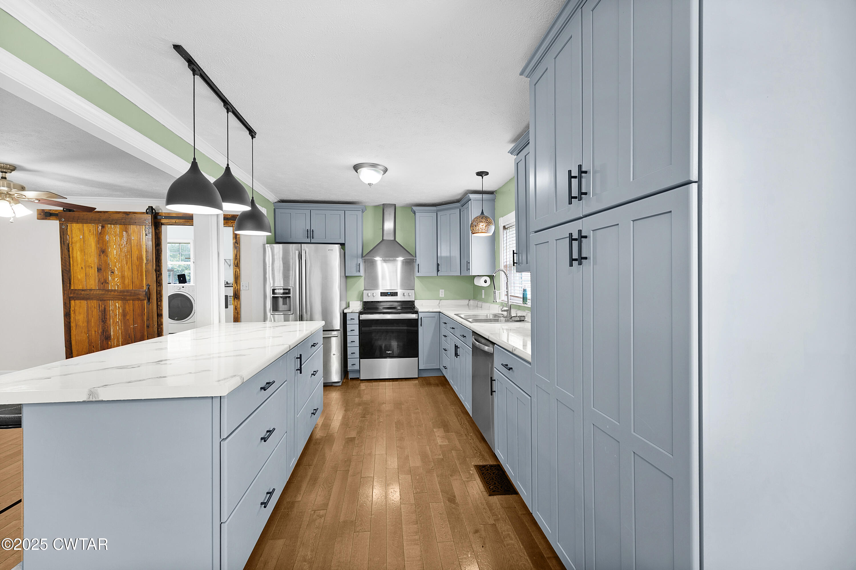 1675 Emerson Road Henderson, TN 38340 - Photo 14 of 21 a kitchen with cabinets and wooden floor