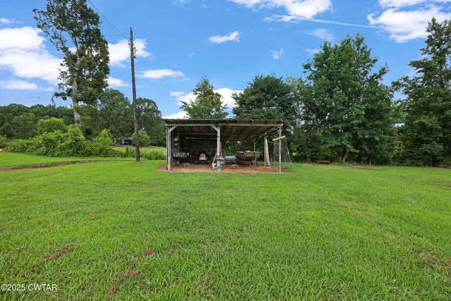 a view of a house with backyard and a sitting area