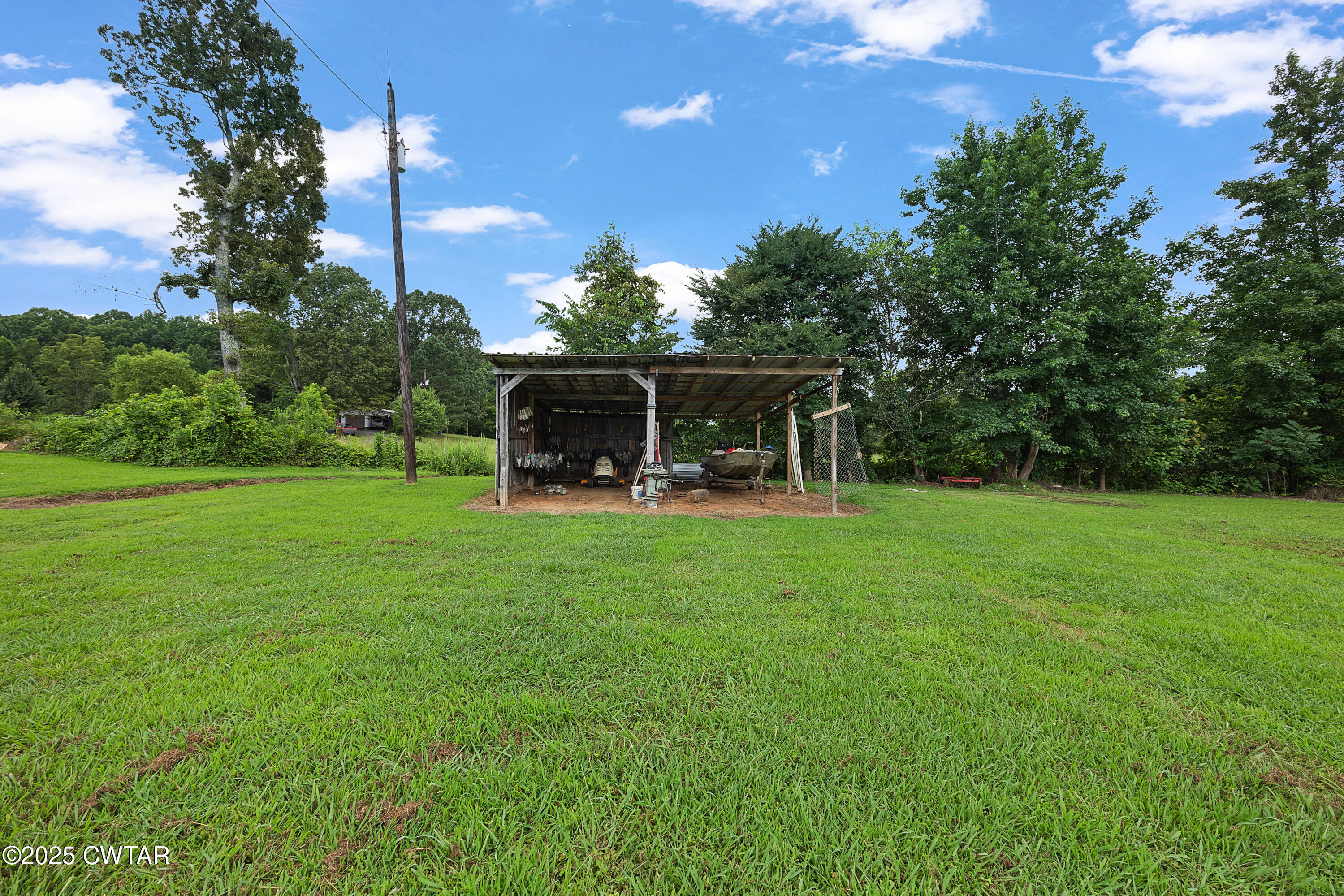 1675 Emerson Road Henderson, TN 38340 - Photo 3 of 21 a view of a house with backyard and a sitting area