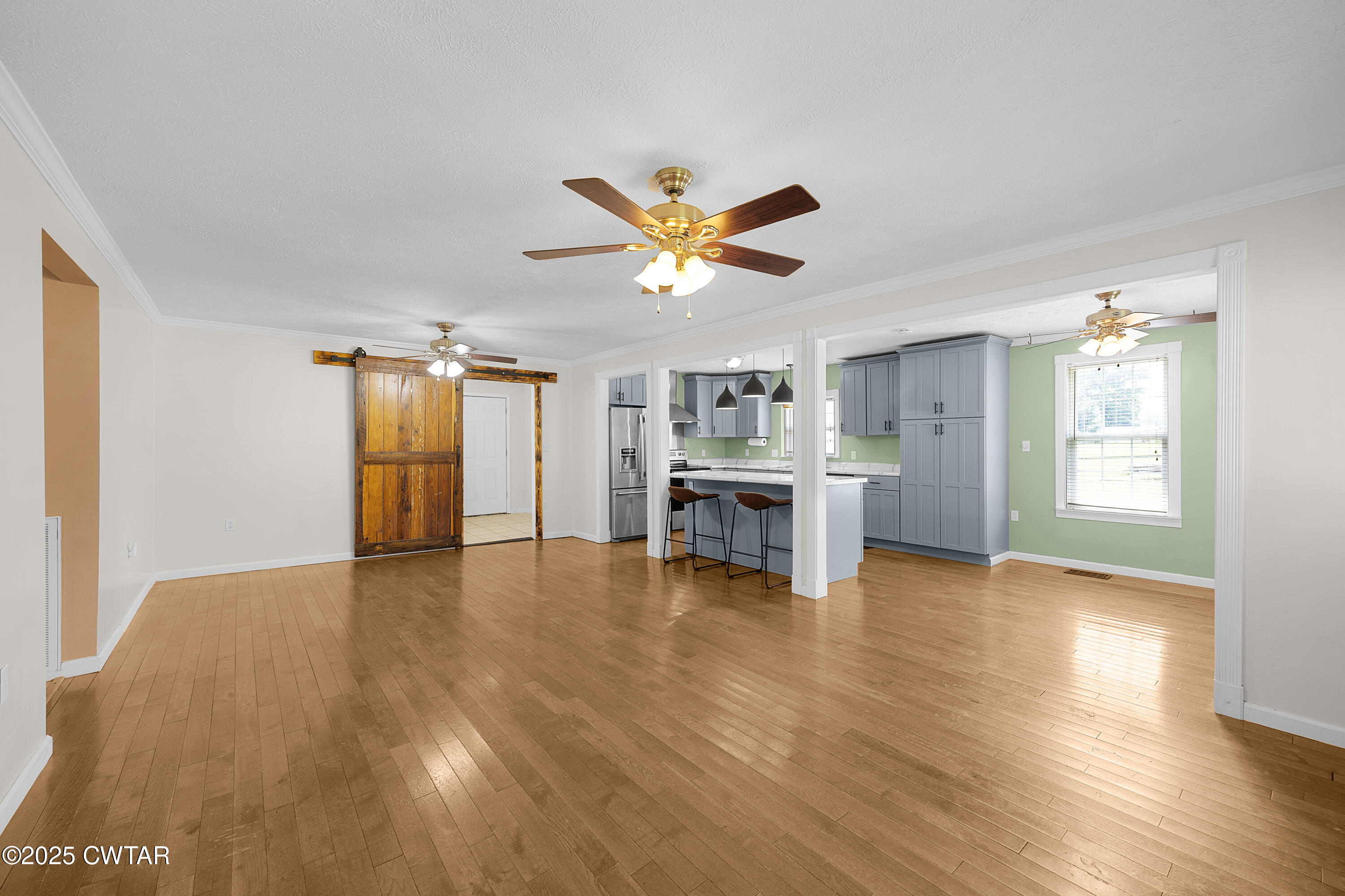 1675 Emerson Road Henderson, TN 38340 - Photo 9 of 21 a view of an empty room with kitchen and window