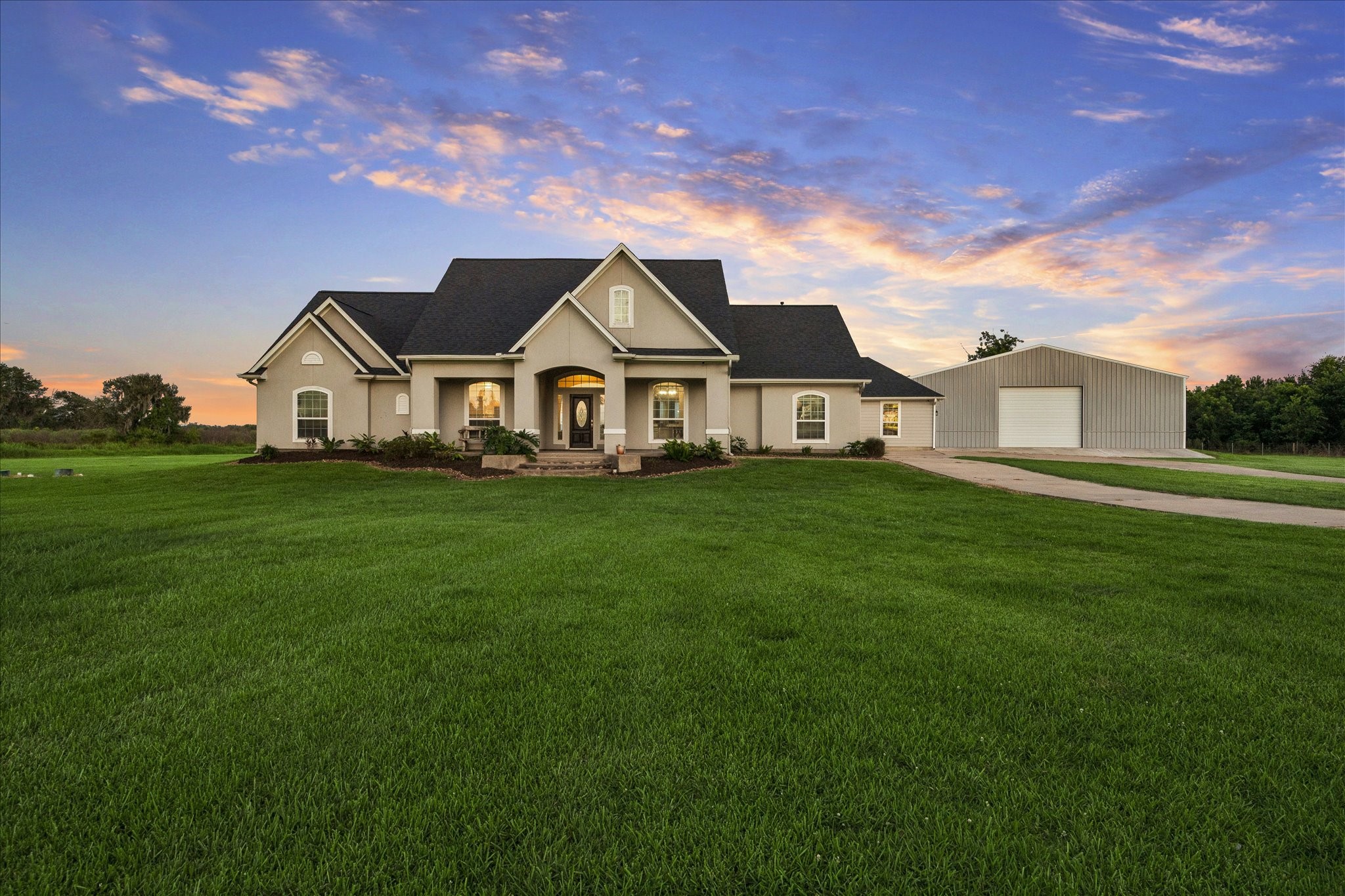 2702 Horseshoe Lane Rosharon, TX 77583 - Photo 1 of 43 Stunning front elevation with automatic gated entrance, expansive front lawn, exceptional curb appeal, and a 4,800 square foot shop