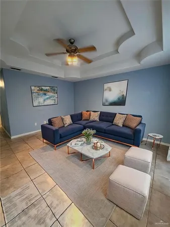 a living room with furniture a rug and a window