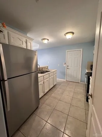 a kitchen with stainless steel appliances a refrigerator and a sink