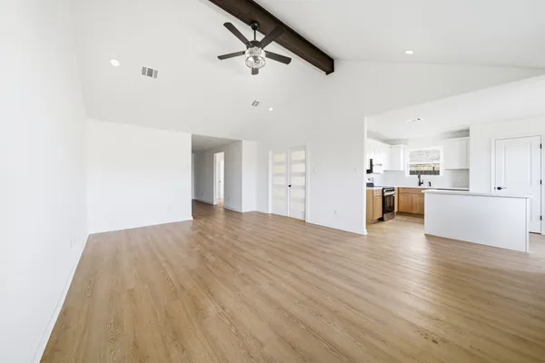 a view of a kitchen with a sink and wooden floor
