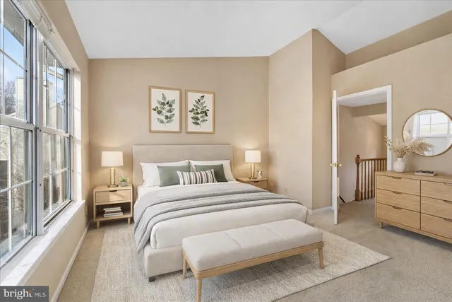 a bedroom with a bed and a large window