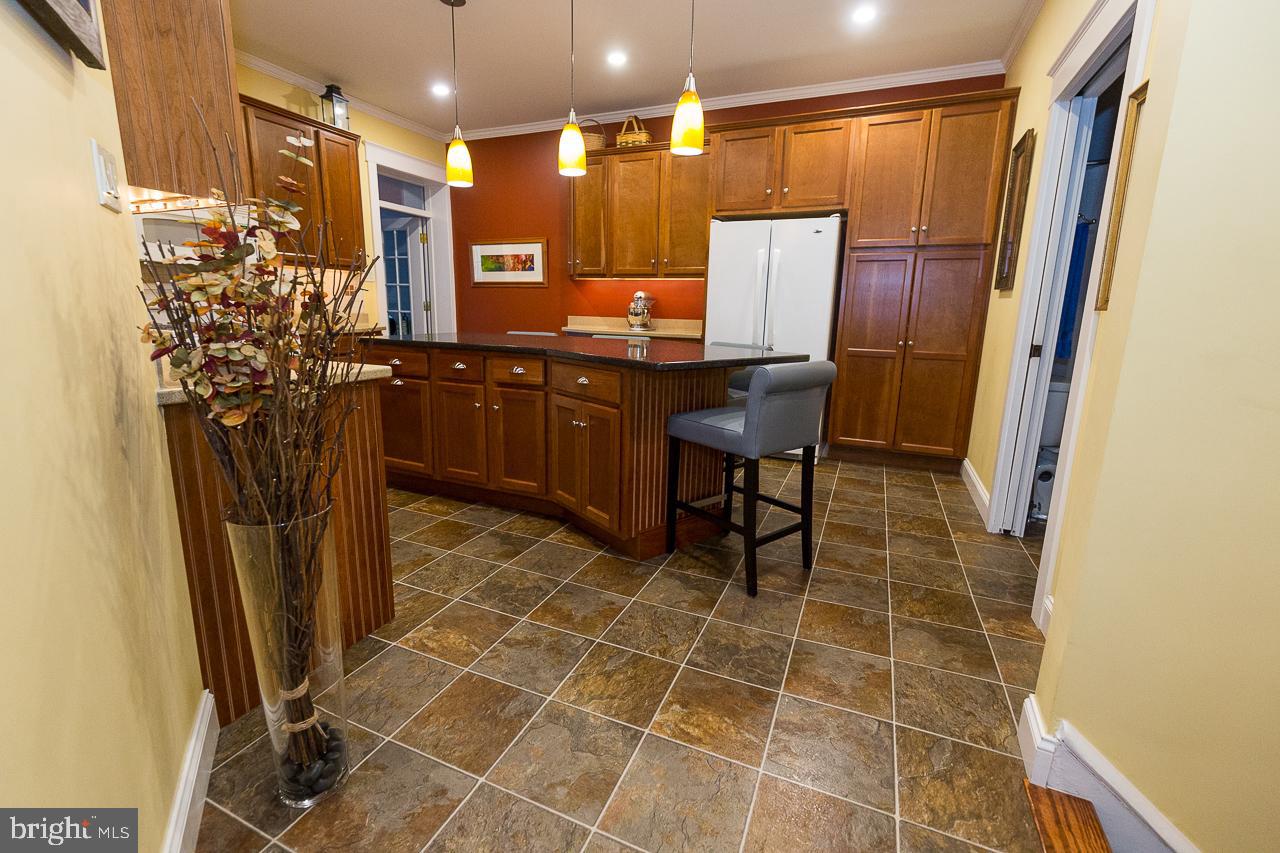1043 Washington Street Reading, PA 19601 - Photo 13 of 40 a view of a kitchen with stainless steel appliances a refrigerator and a counter top space
