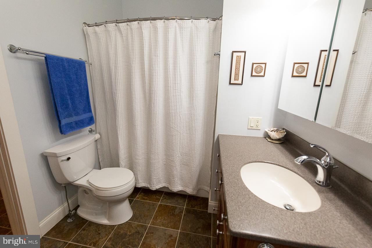 1043 Washington Street Reading, PA 19601 - Photo 17 of 40 a bathroom with a sink toilet and a mirror