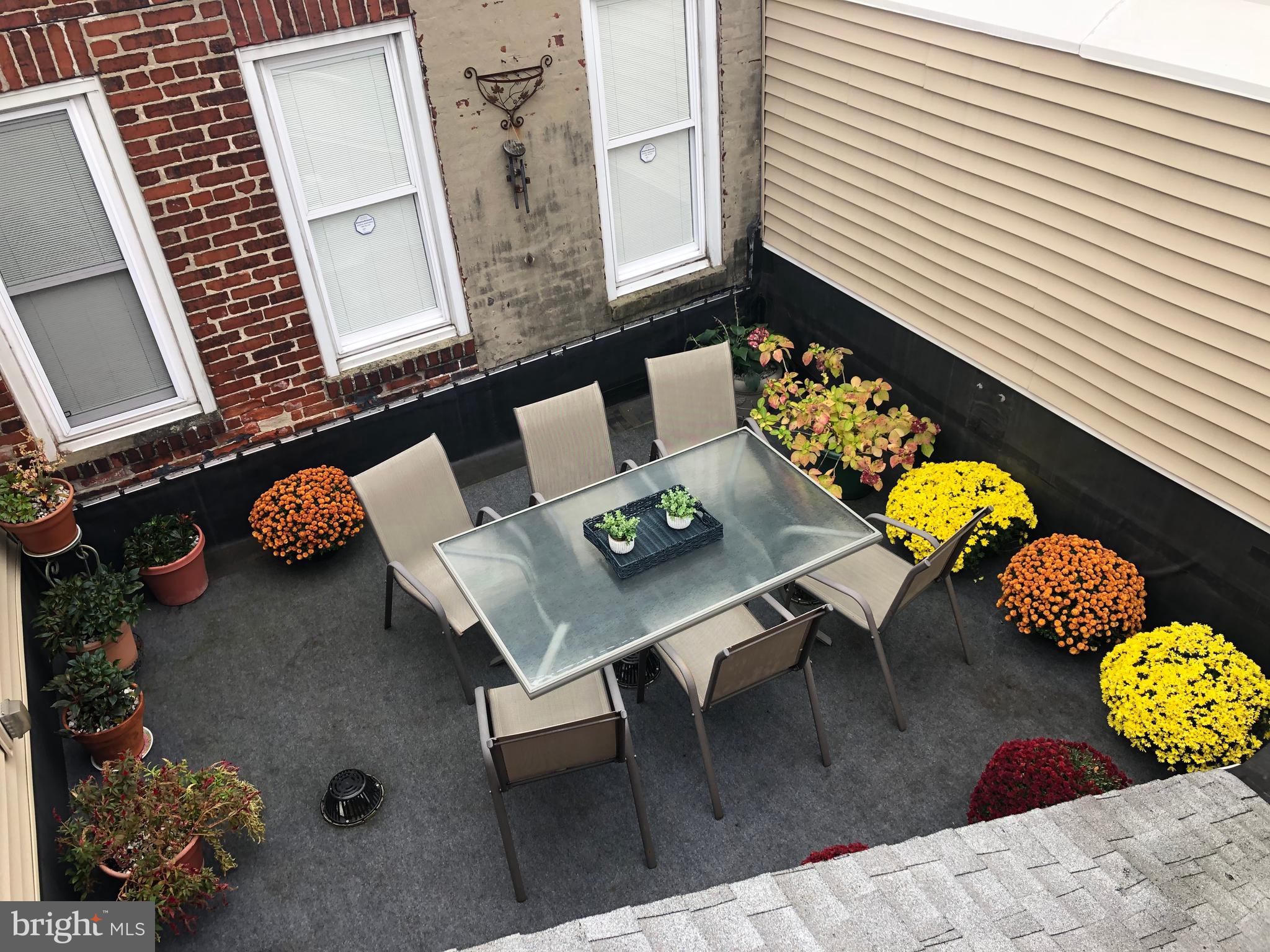 1043 Washington Street Reading, PA 19601 - Photo 23 of 40 a living room with furniture and flowers