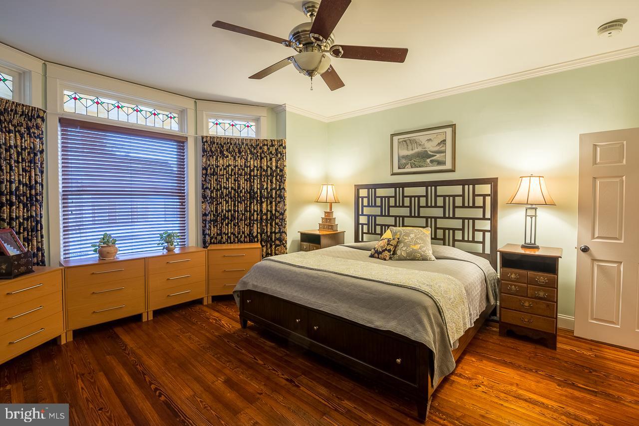 1043 Washington Street Reading, PA 19601 - Photo 28 of 40 a bedroom with a bed and a chandelier