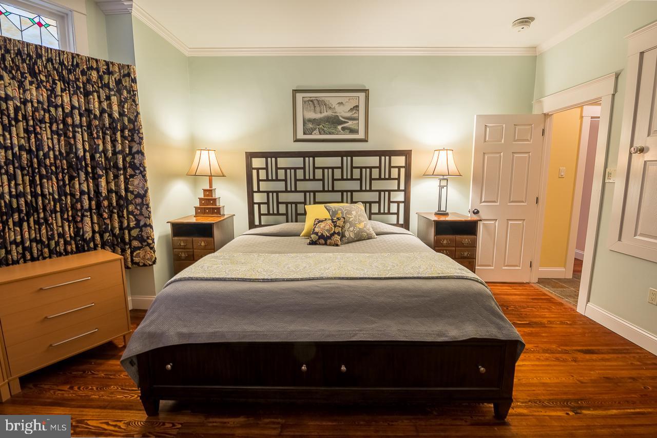 1043 Washington Street Reading, PA 19601 - Photo 29 of 40 a bedroom with a bed and wooden floor