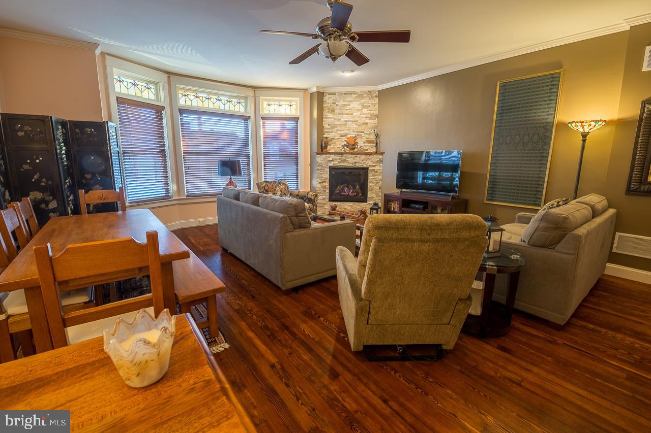 1043 Washington Street Reading, PA 19601 - Photo 3 of 40 a living room with fireplace furniture and a large window