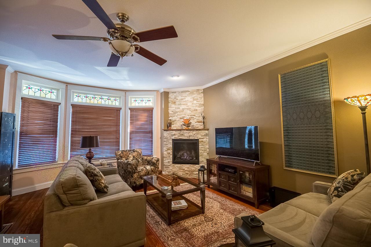 1043 Washington Street Reading, PA 19601 - Photo 4 of 40 a living room with furniture a fireplace and a flat screen tv