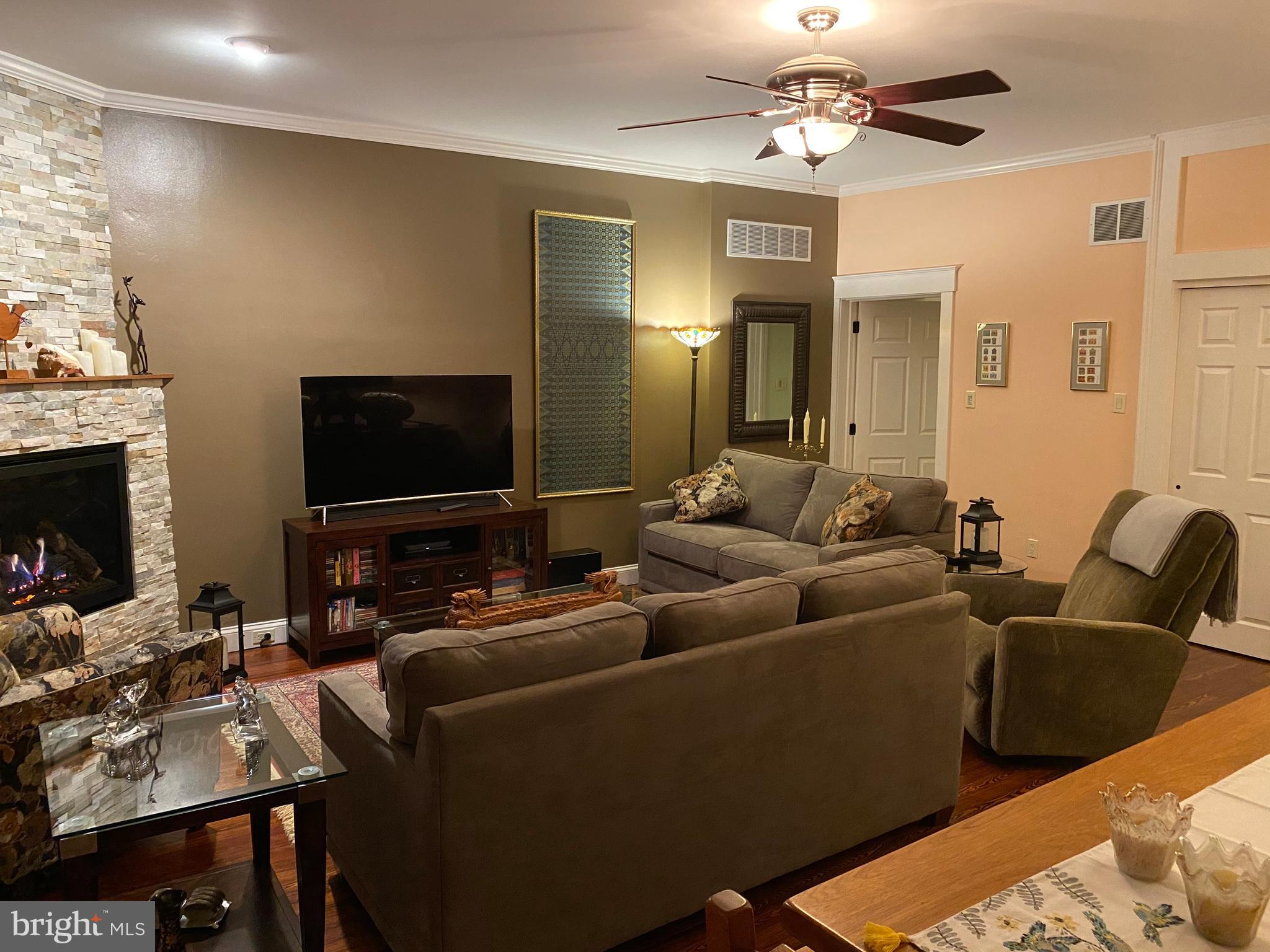 1043 Washington Street Reading, PA 19601 - Photo 5 of 40 a living room with furniture a fireplace and a flat screen tv