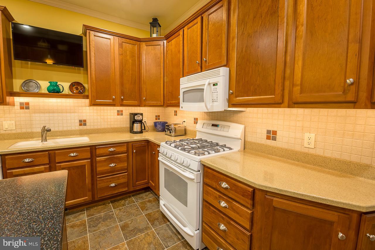 1043 Washington Street Reading, PA 19601 - Photo 9 of 40 a kitchen with a cabinets and white appliances