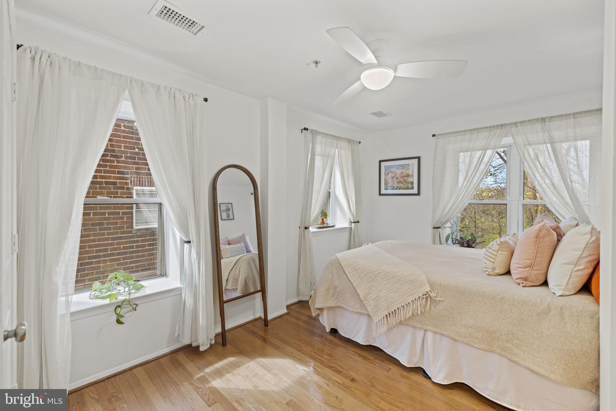 a bedroom with a large bed and a window