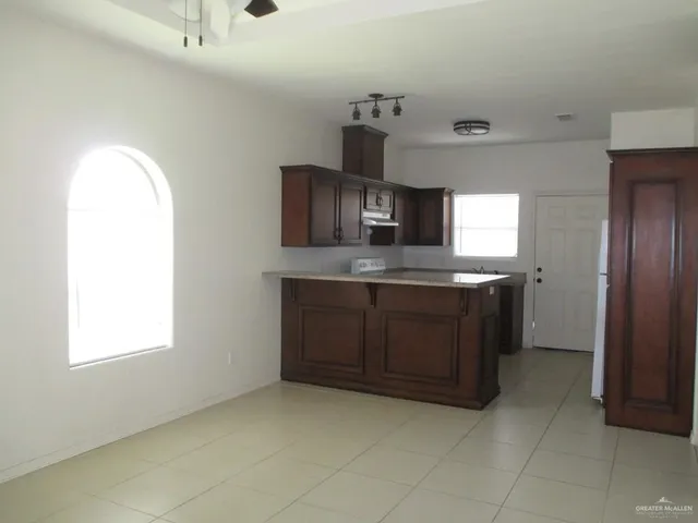 a kitchen with a sink a stove and cabinets
