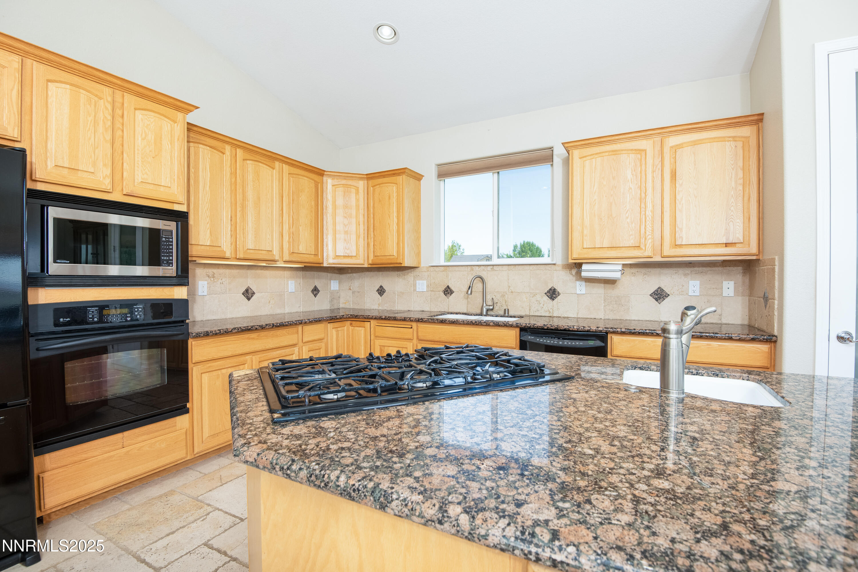 544 Upper Colony Road Wellington, NV 89444 - Photo 11 of 47 a kitchen with stainless steel appliances granite countertop a stove a sink and a microwave