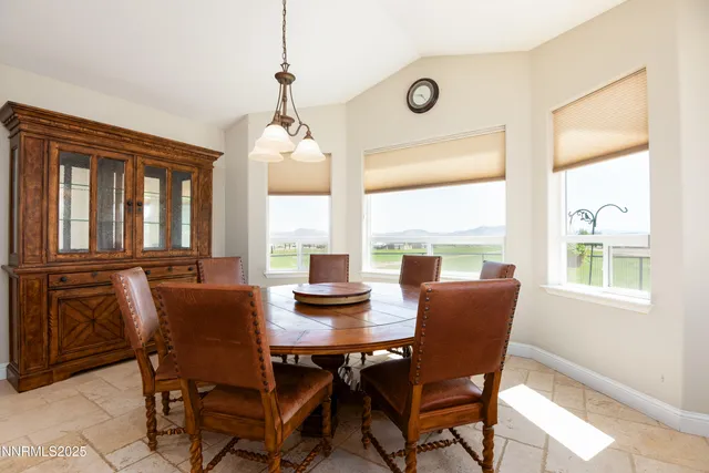 a dining room with furniture a chandelier and wooden floor