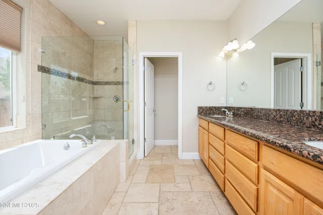 a spacious bathroom with a granite countertop tub shower and a sink