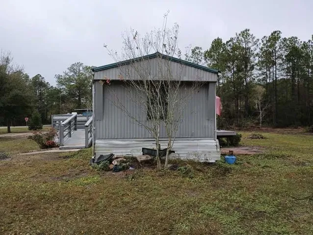 a backyard of a house with table and chairs