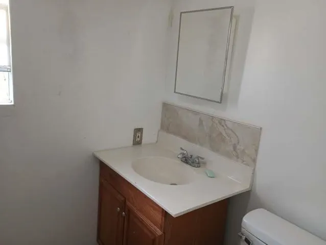a bathroom with a sink toilet and vanity