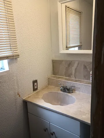 a bathroom with a sink and a window