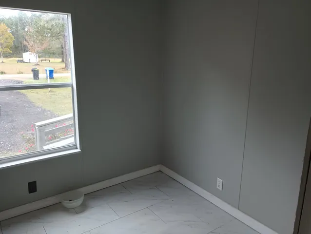 a view of an empty room and a window