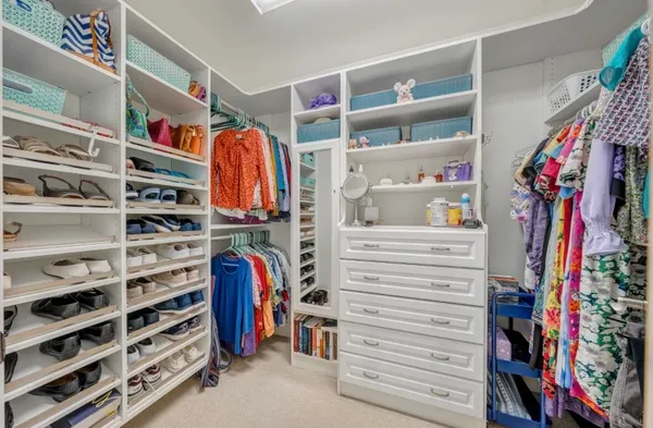 an aerial view of a house with a garden and lake view