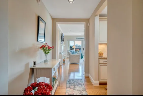 a living room with furniture a fireplace and a large window