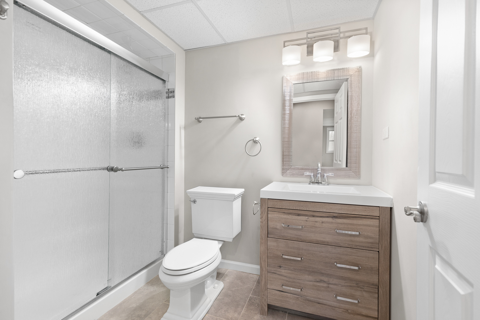 301 Stonegate Road New Lenox, IL 60451 - Photo 11 of 26 a bathroom with a granite countertop toilet a sink and a mirror