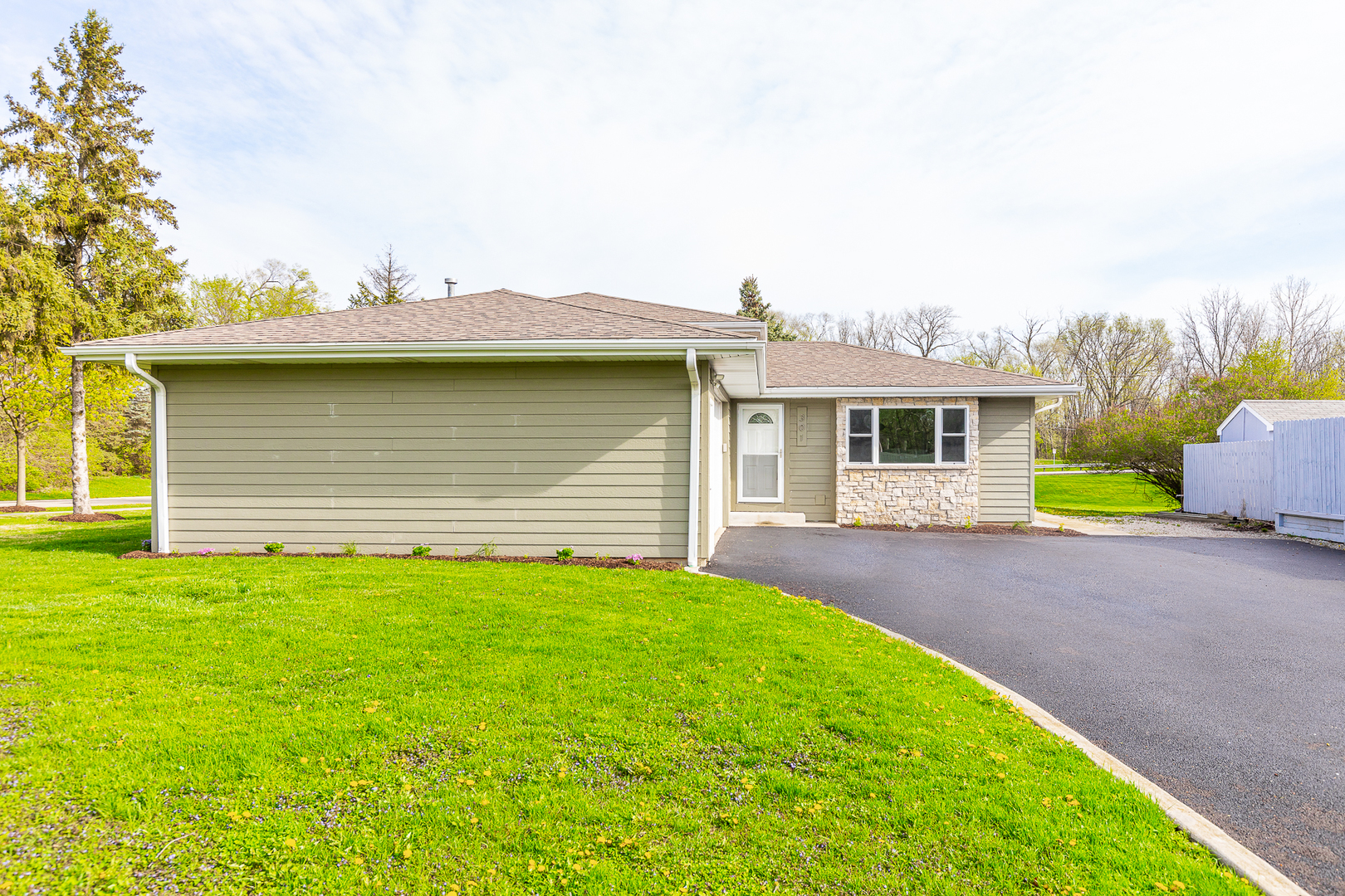 301 Stonegate Road New Lenox, IL 60451 - Photo 22 of 26 a front view of a house with a garden