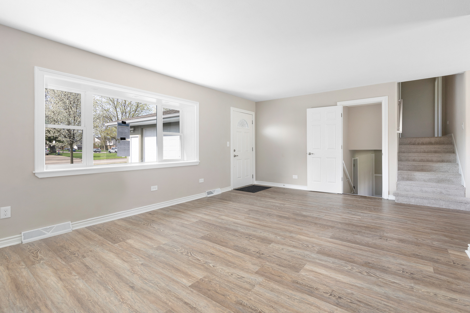 301 Stonegate Road New Lenox, IL 60451 - Photo 3 of 26 a view of an empty room with wooden floor and a window