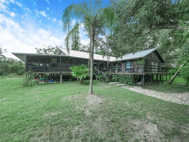 a backyard of a house with table and chairs