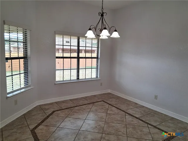 a view of a windows and chandelier in a room